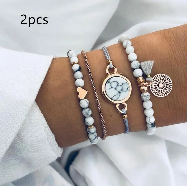 A four-piece geometric pine stone bracelet set made of alloy with an electroplated finish and resin stones, offering a sleek and versatile fashion accessory.