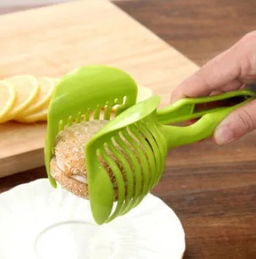 Plastic fruit and vegetable cutting holder slicer in black or green, measuring 18.5cm by 8cm