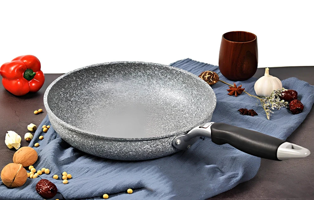 Japanese-style Maifan stone frying pan with glass lid showing non-stick surface and compound bottom