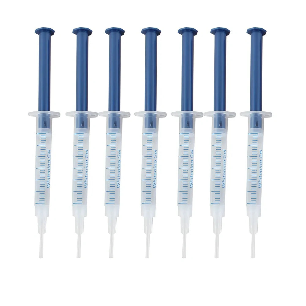 Teeth whitening gel kit with thermoform trays, cold light lamp, 10 gel syringes, and 3D shade guide showing 7-10 improvement