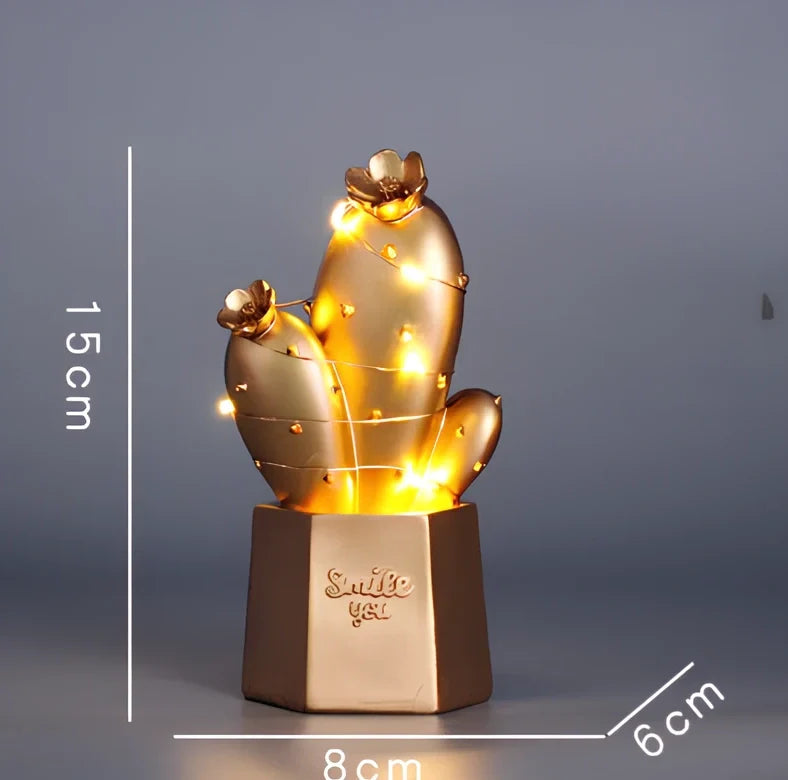 Cactus-shaped resin night light in gold finish measuring 15cm tall with warm LED glow