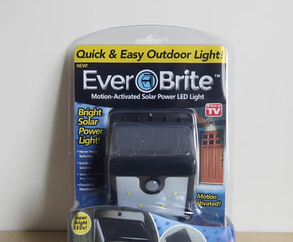 Solar 4 LED sensor lights mounted on garden wall, showing motion detection range and bright illumination at night