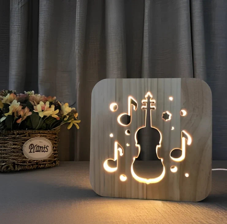 Wood-carved music instrument LED night light with USB cable showing guitar, saxophone, and violin designs