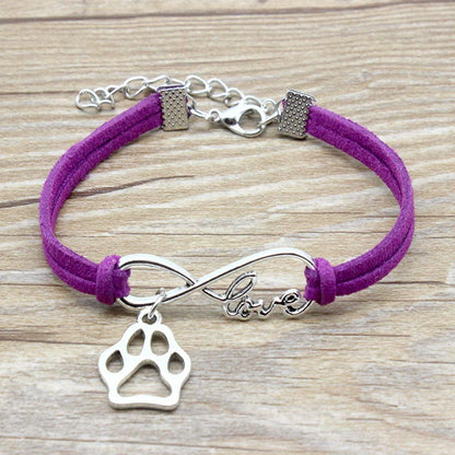 Hand-woven Infinite Love Pet Bracelet in various colors, showcasing the bow shape and alloy material.