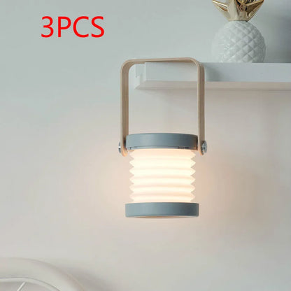 White foldable USB rechargeable LED night light in both table lamp and tall lantern modes.