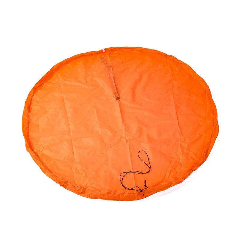 A large, waterproof travel picnic mat made of durable nylon with convenient toy storage bags for outdoor adventures.