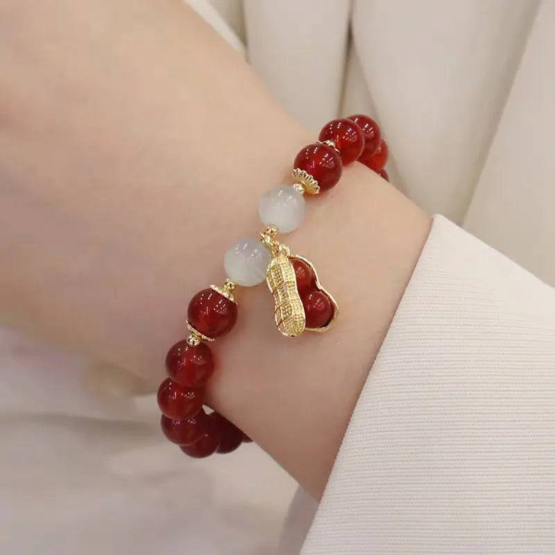 Chinese style glass bead bracelet with bamboo joint design on wrist.