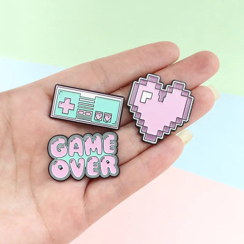 Stereo game console badge made from alloy metal in three colour options for bag mounting.