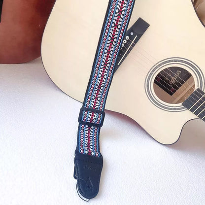Adjustable embroidered guitar strap with durable webbing and intricate design