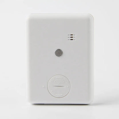 Black and white metal kitchen timer with magnetic back on a refrigerator door
