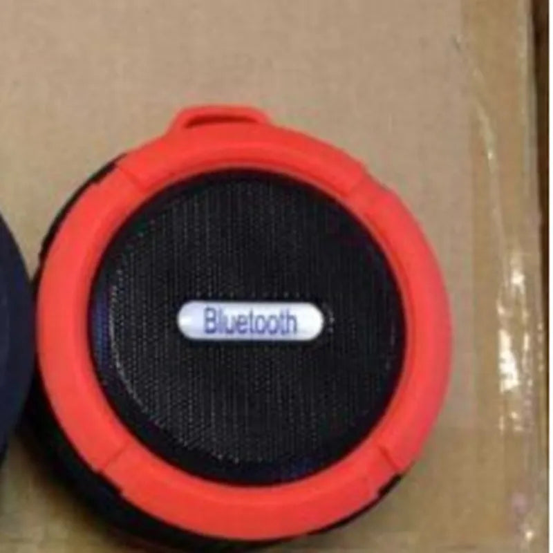 C6 portable waterproof Bluetooth speaker in multiple colours with a mounting clip attached.