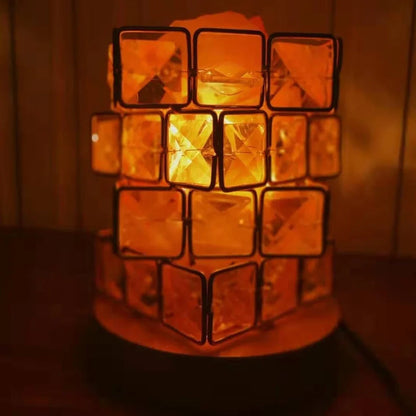 Himalayan salt lamp with wooden base and dimmable switch showing pink and orange salt rocks