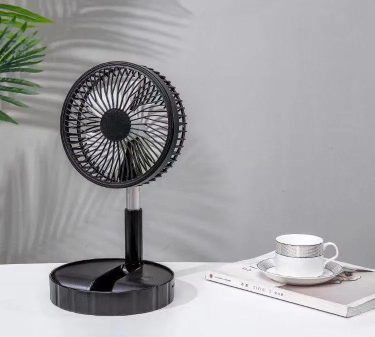 Black telescopic portable folding fan shown extended to full height on a desk, with control panel visible.
