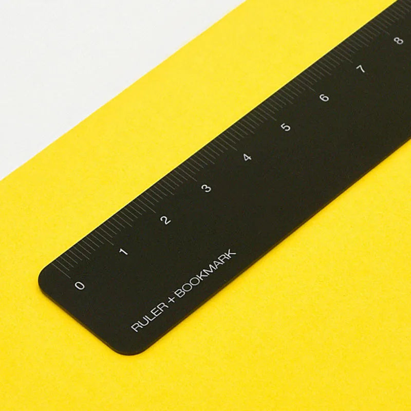 Aluminum bookmark ruler showing 15cm scale with laser-engraved markings in retro design