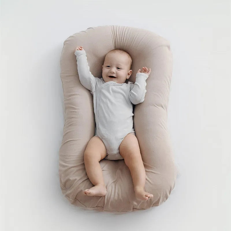 Beige portable cotton baby nest crib measuring 75 by 45 centimetres for newborn infants