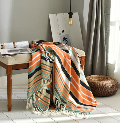 130x150cm knitted acrylic blanket with 10cm fringe detailing in beige colour draped over sofa