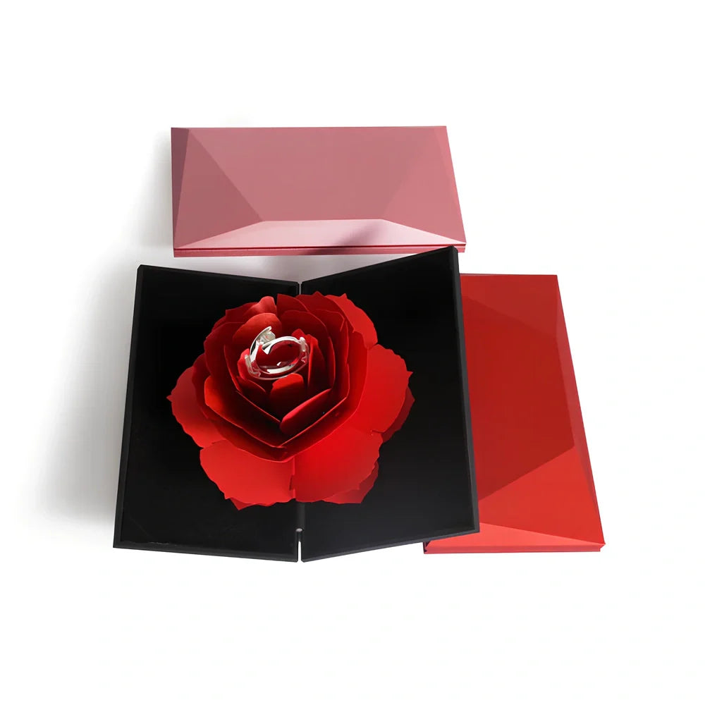 Rotating ring box with embossed paper exterior showing 360-degree mechanism and flannel interior