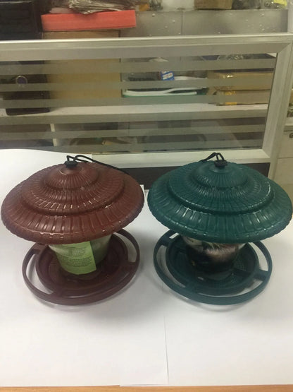 Hanging plastic transparent bird feeder, 18cm x 18cm x 19cm, shown in green or red.