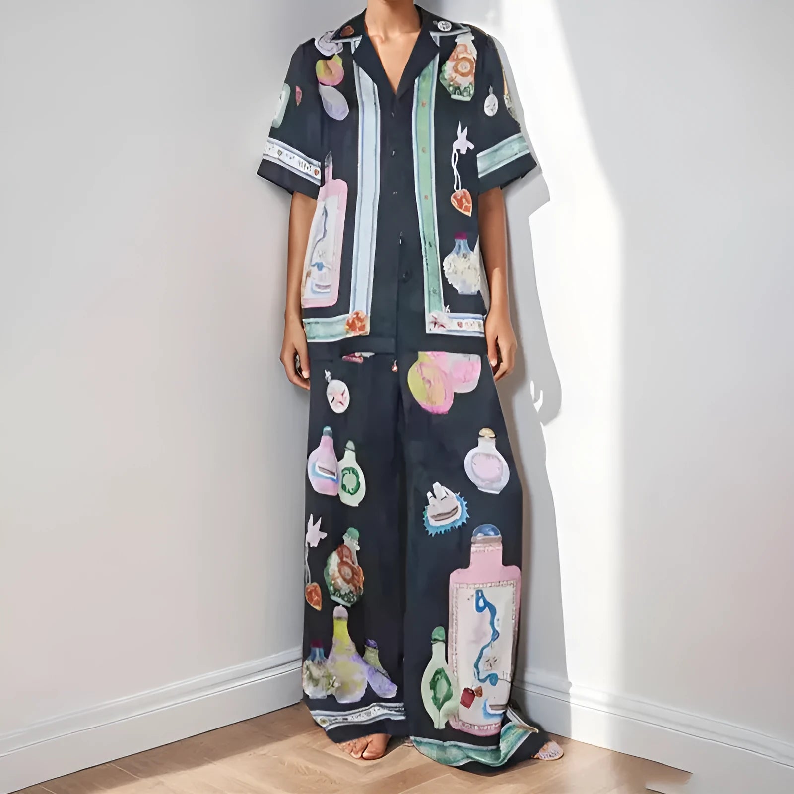 Black women's cardigan set with cartoon animation print, showing top with regular sleeves and matching trousers