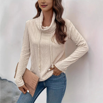 Apricot coloured long sleeve hooded pullover sweater with drawstring on a hanger