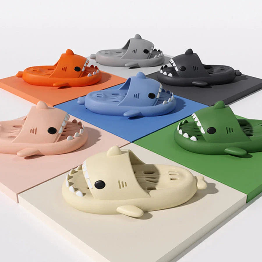 Colorful shark-themed shower slides with drainage holes, designed for comfortable and practical use in the pool or shower.