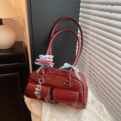 Retro brown PU leather women's pillow bag with a double shoulder strap and flap closure.