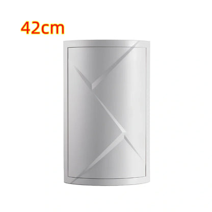 White triangle corner shelf with three tiers mounted in bathroom corner holding toiletries