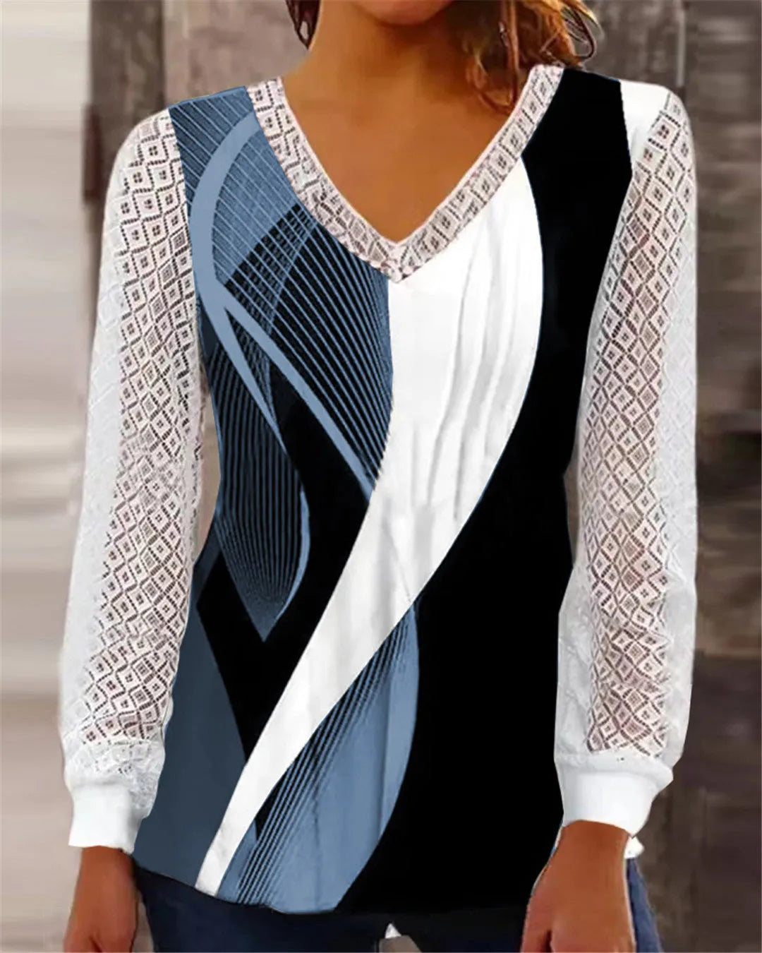 Purple V-neck loose top with hollow-out lace print and long sleeves.