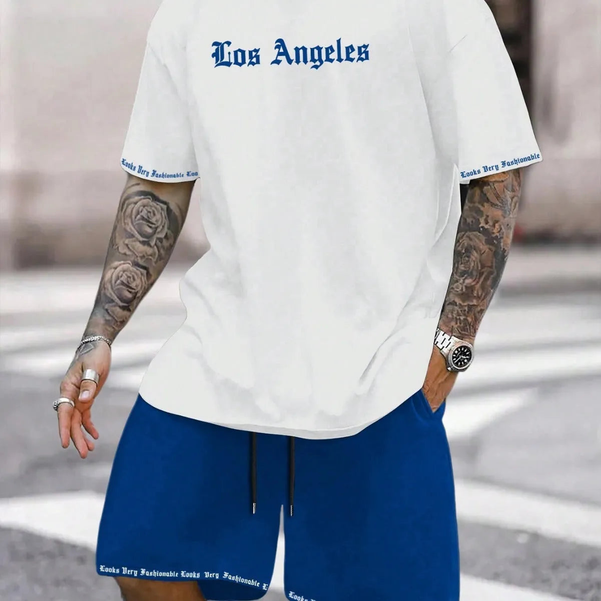 Man wearing a grey short-sleeve sports top and matching shorts from the quick-dry polyester set.