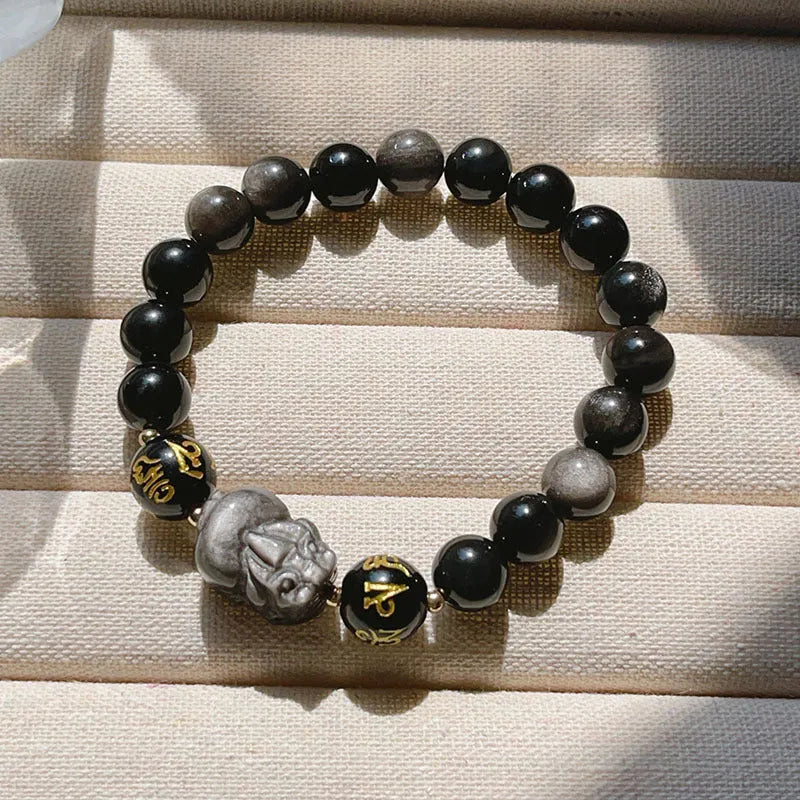 Men's silver stone bracelet with engraved proverb beads and Chinese zodiac style on a wrist.