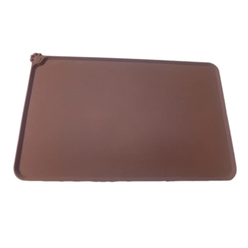 Silicone pet food mat with raised edges and non-slip base to contain messes and protect floors during pet mealtimes
