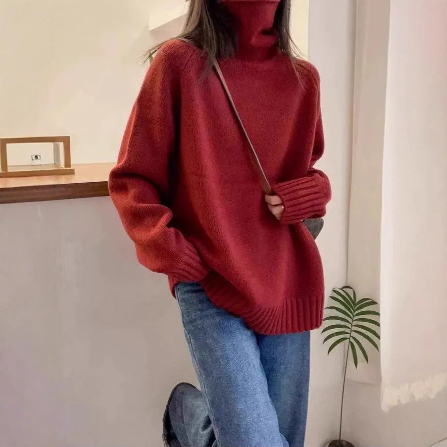 Women's turtleneck sweater in loose fit with thick curling pile collar, available in red, camel, grey, and black colours