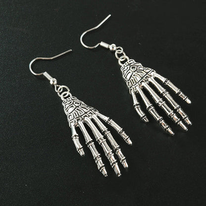 Vintage-inspired skull and skeleton earrings with intricate enamel details and a spooky-chic design