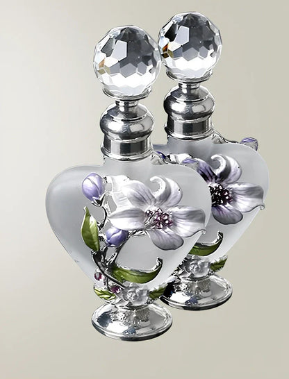 Heart-shaped refillable perfume bottle with metal and crystal construction, 3.6 inches tall