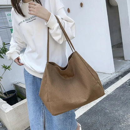 Solid colour women's canvas handbag with double shoulder straps showing internal mobile phone compartment