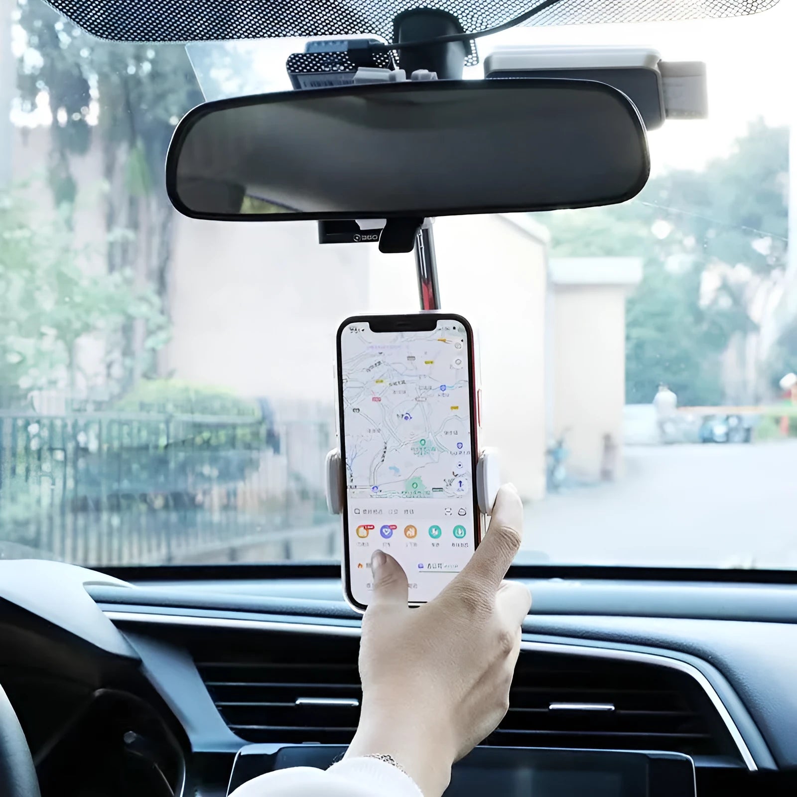 Black ABS plastic mobile phone bracket mounted on a car rearview mirror.