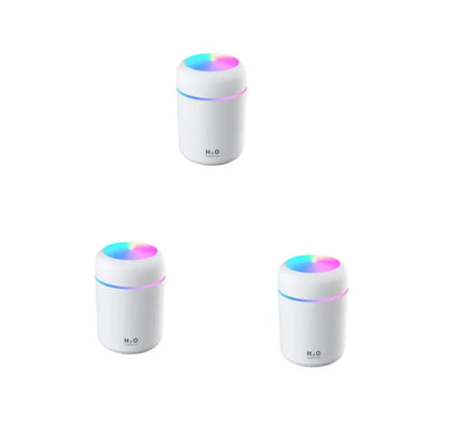 Pink car air purifying humidifier with LED lights on, next to a USB cable.
