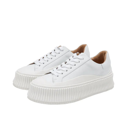 Women's black suede platform trainers with cross-strap binding and thick rubber soles