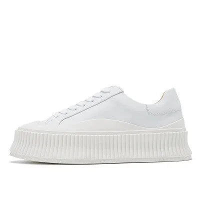 Women's black suede platform trainers with cross-strap binding and thick rubber soles