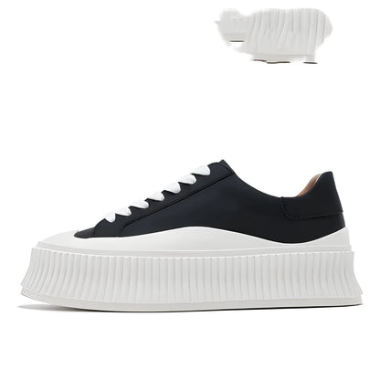 Women's black suede platform trainers with cross-strap binding and thick rubber soles
