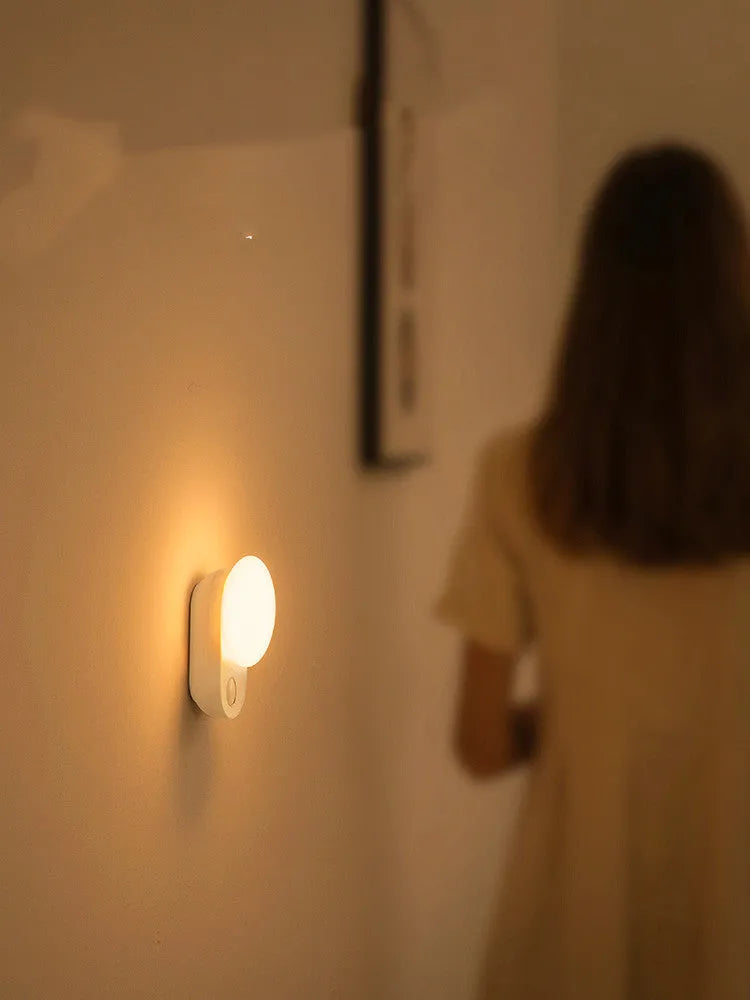 Baseus white sensor night light with circular design showing LED illumination and motion detection sensor