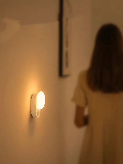 Baseus white sensor night light with circular design showing LED illumination and motion detection sensor