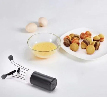 White and black wireless automatic kitchen stirrer with three-speed button, shown next to a saucepan.