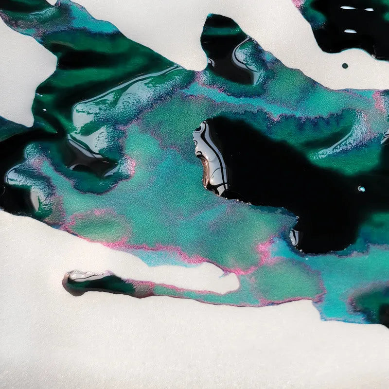 Bottle of strong sheen gradient fountain pen ink with gold powder particles in Red Tide colour.