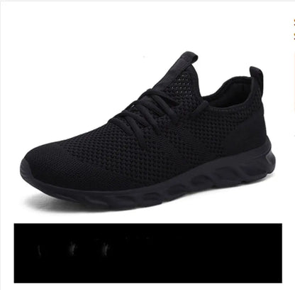 Men's black and white mesh sneakers with a lace-up front and round toe, shown on a plain background.