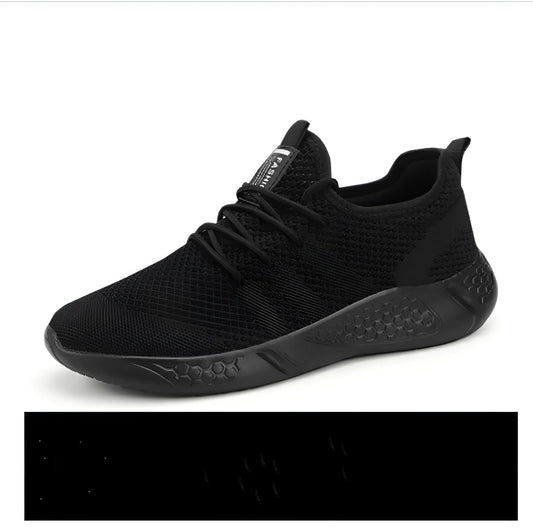 Men's black and white mesh sneakers with a lace-up front and round toe, shown on a plain background.