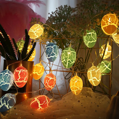 Crack egg LED string lights shaped around window with coloured plastic shells and flexible cable