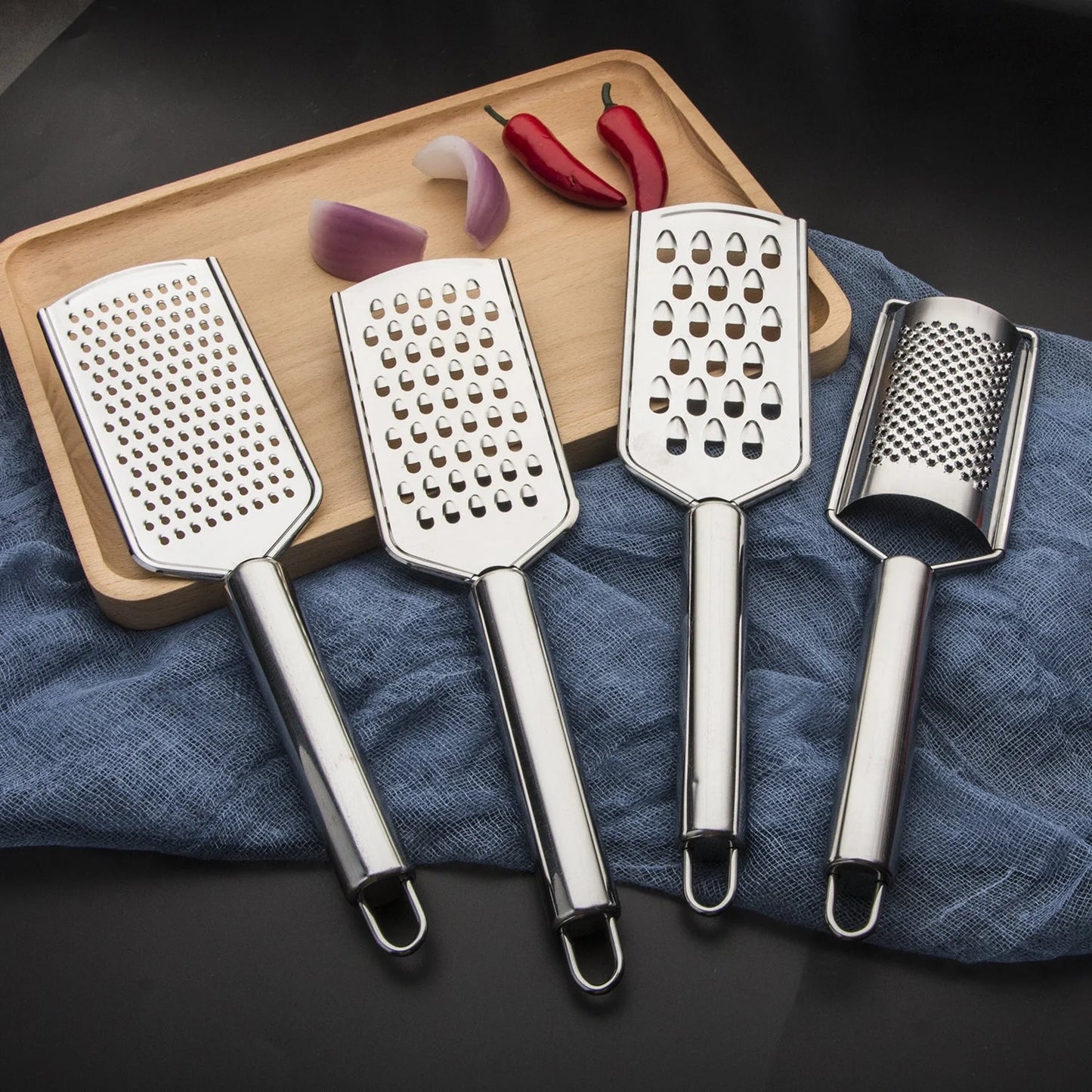 Stainless steel kitchen grater set with four grating options for cheese, vegetables, and ginger