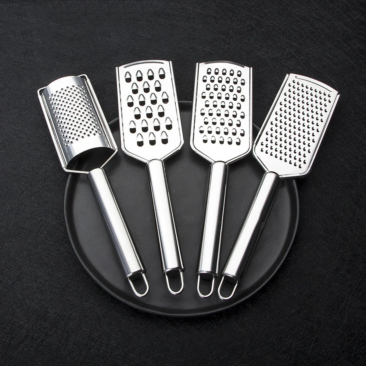 Stainless steel kitchen grater set with four grating options for cheese, vegetables, and ginger