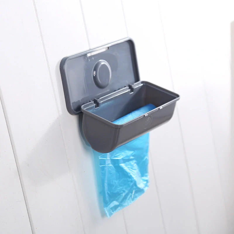Wall-mounted plastic trash bag dispenser in white, grey, and pink for kitchen organization
